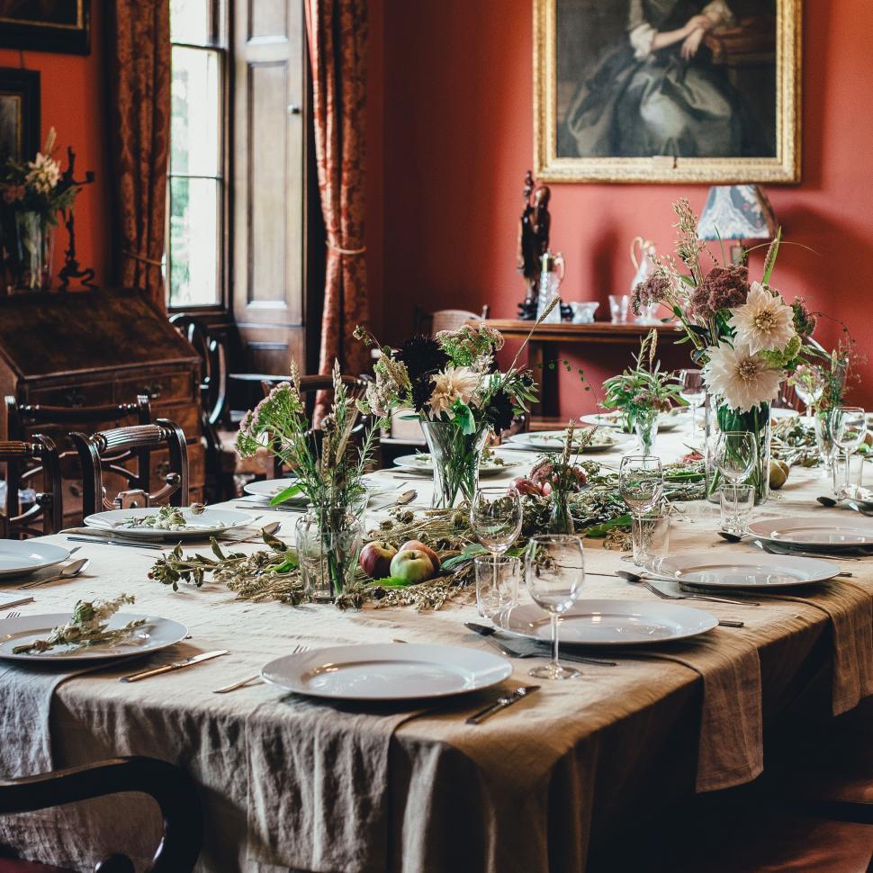 Free Image of Long Table Set With Plates and Flowers 