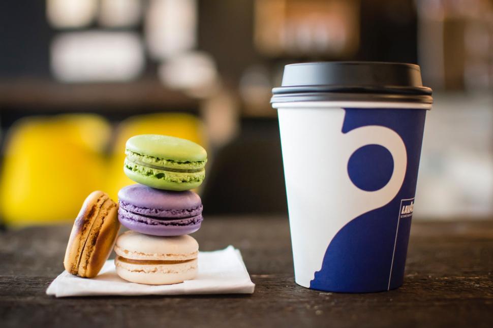Free Image of A Cup of Coffee Next to a Stack of Macaroons 
