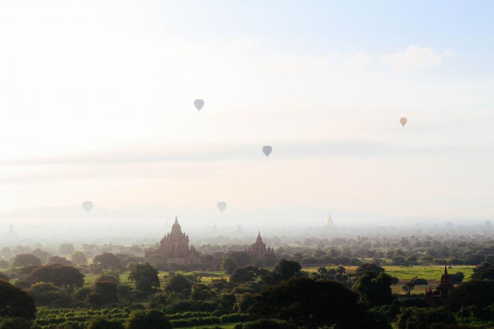 Free Image of Many Hot Air Balloons Flying Over a City 