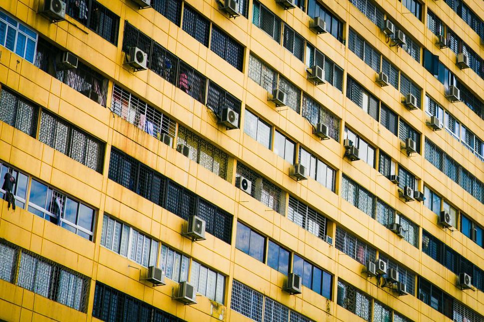 Free Image of Tall Yellow Building With Lots of Windows 
