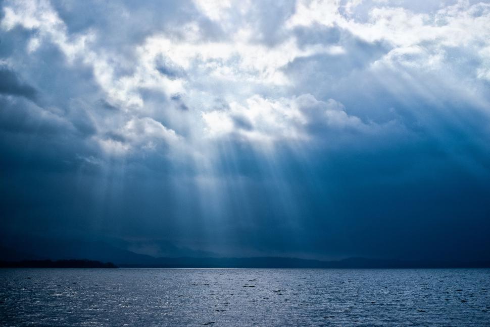 Free Image of Cloudy Sky Over Large Body of Water 
