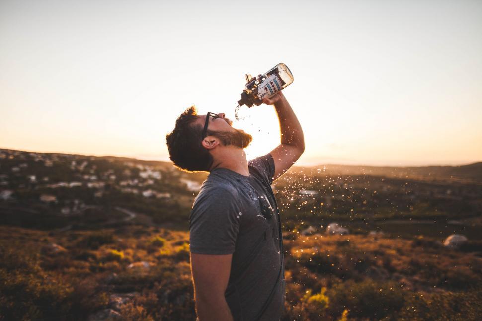 Free Image of Man Drinking Water Out of a Bottle 
