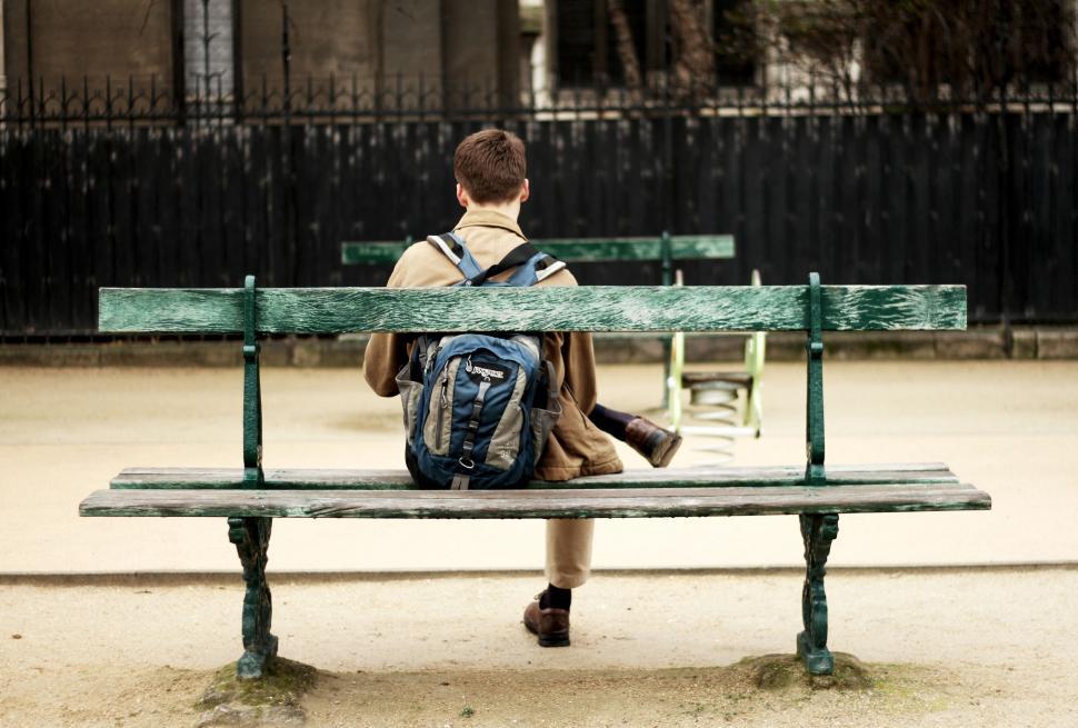 Free Image of Person With Backpack Sitting on Bench 