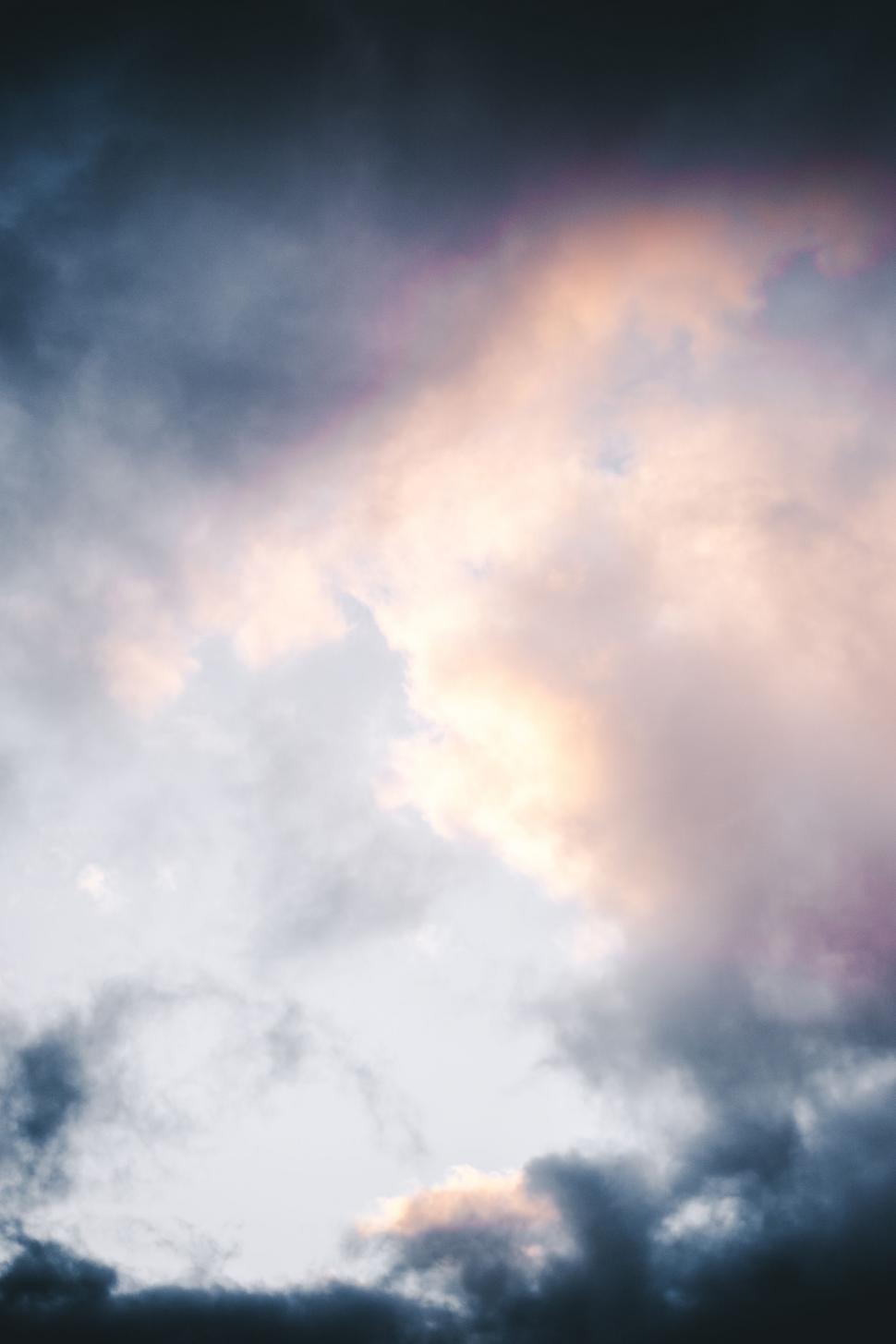 Free Image of A Plane Flying Through a Cloudy Sky 