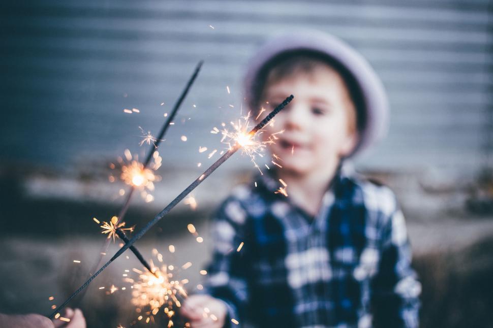 Free Image of Young Boy Holds Sparkler in Hands 