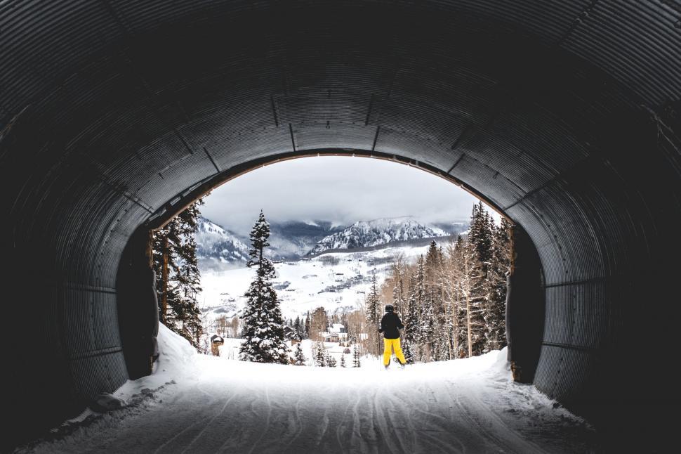 Free Image of Person Standing in Snow-Covered Tunnel 