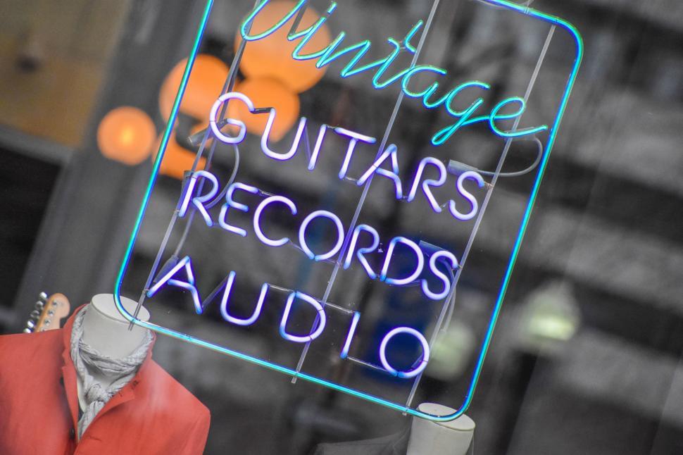 Free Image of Neon Sign Reading Vintage Guitars Records Audio 