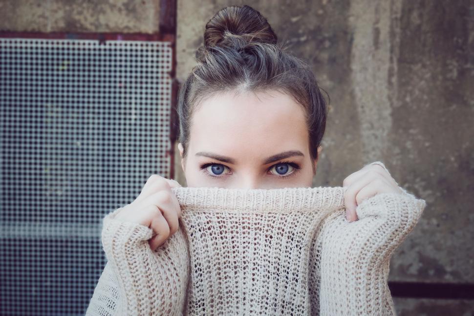 Free Image of Woman Covering Her Face With a Sweater 