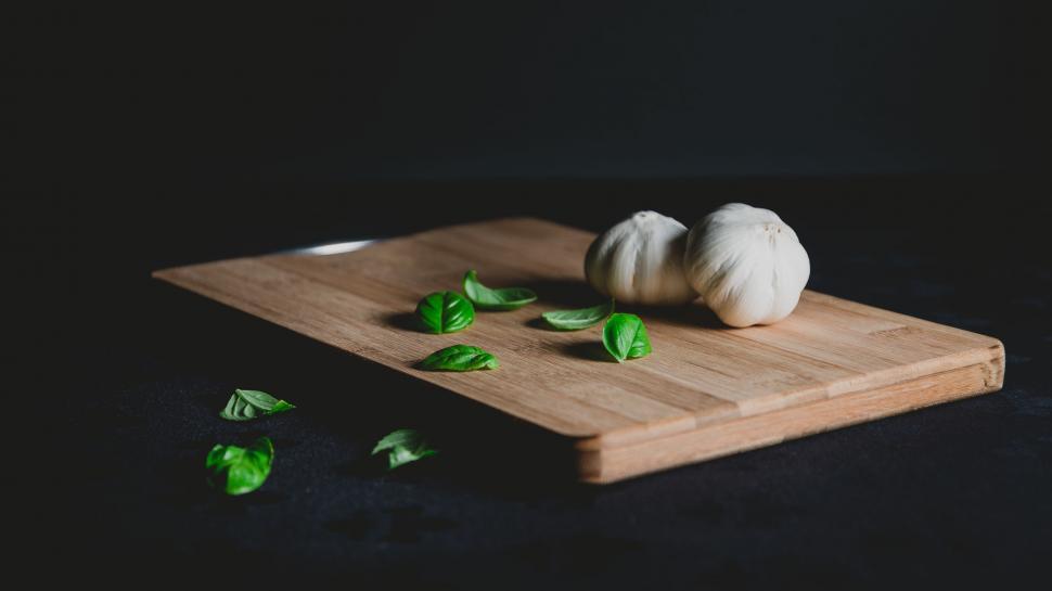 Free Image of Wooden Cutting Board With Green Leaves 