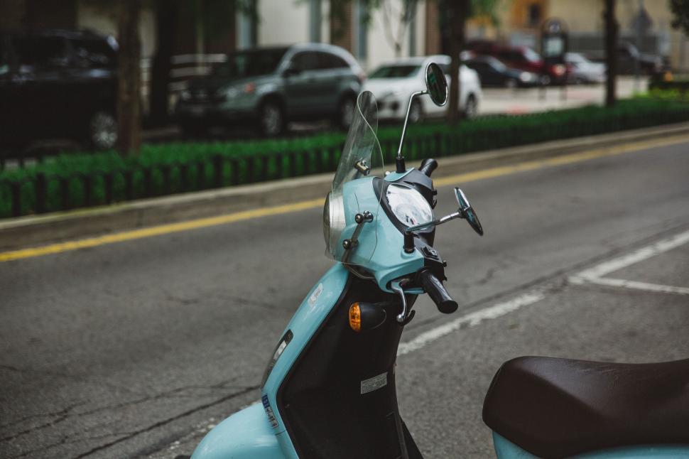 Free Image of Blue Scooter Parked on Side of Road 