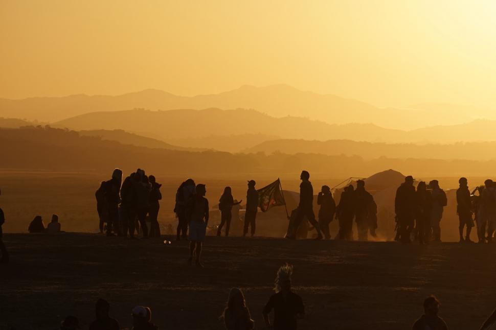 Free Image of Group of People Standing on Top of a Hill 