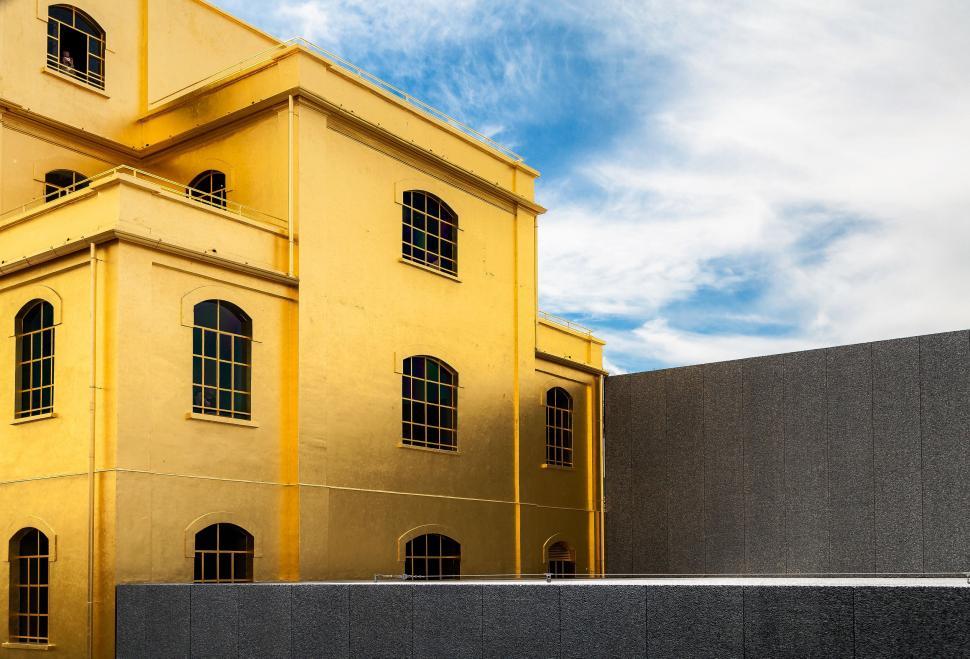 Free Image of Large Yellow Building With Windows 