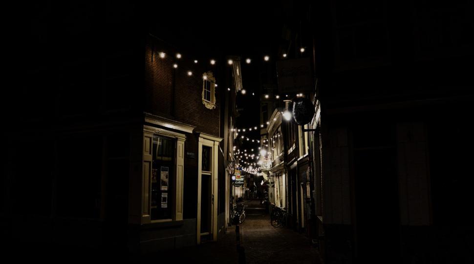 Free Image of Dark Alley With Lights Strung From Buildings 