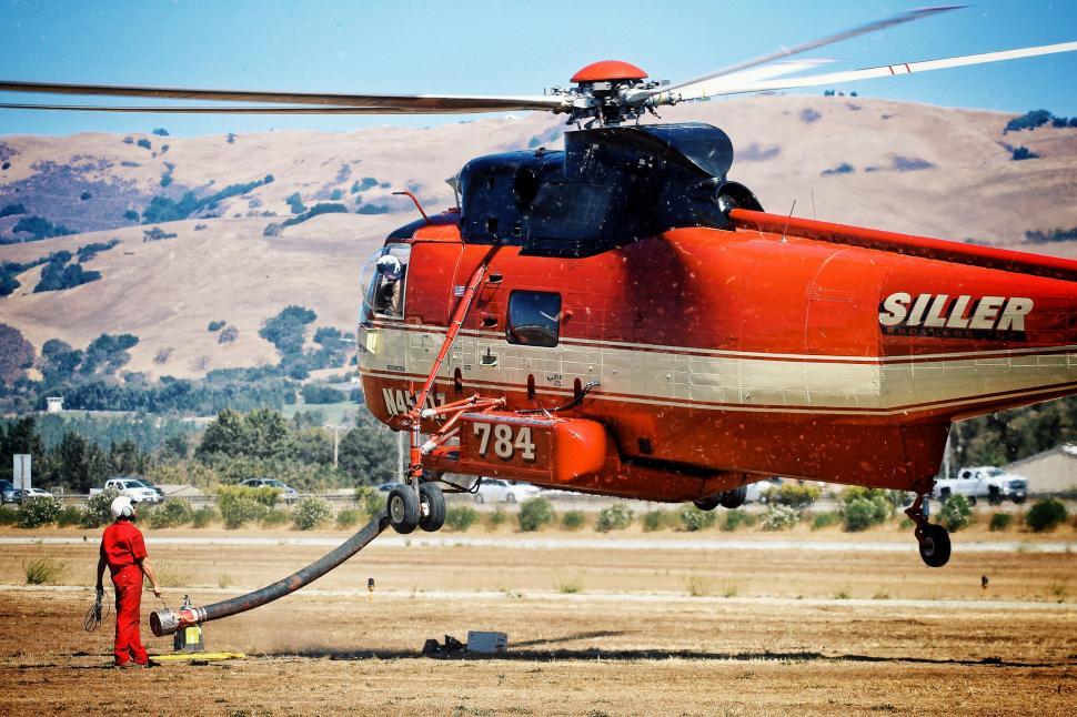 Free Image of Red Helicopter With Water Hose 