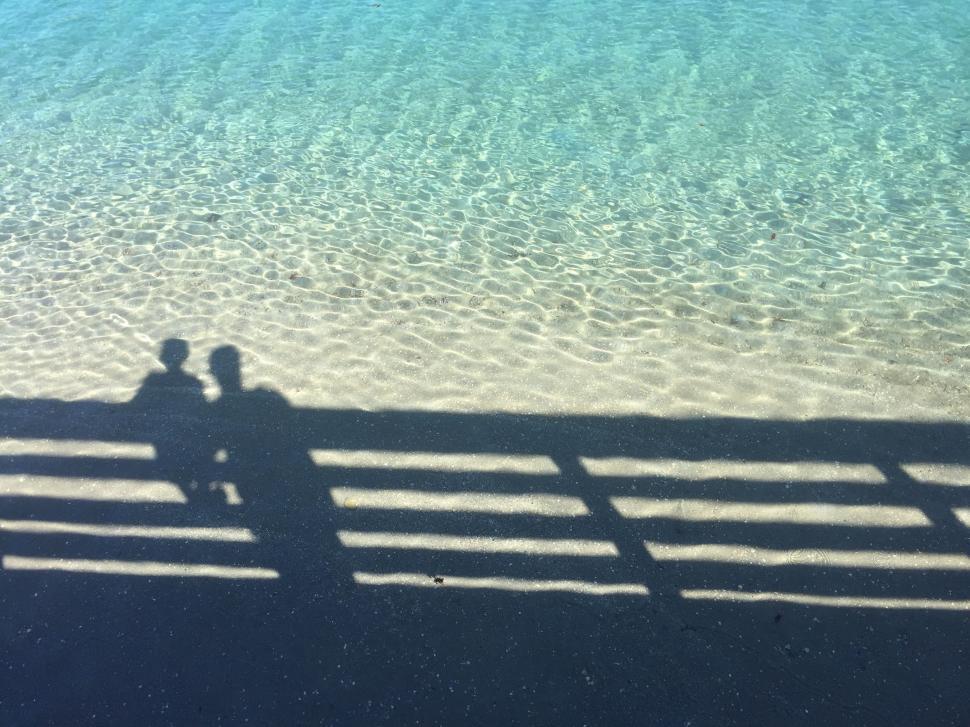 Free Image of Shadow of Two People Sitting on a Bench 