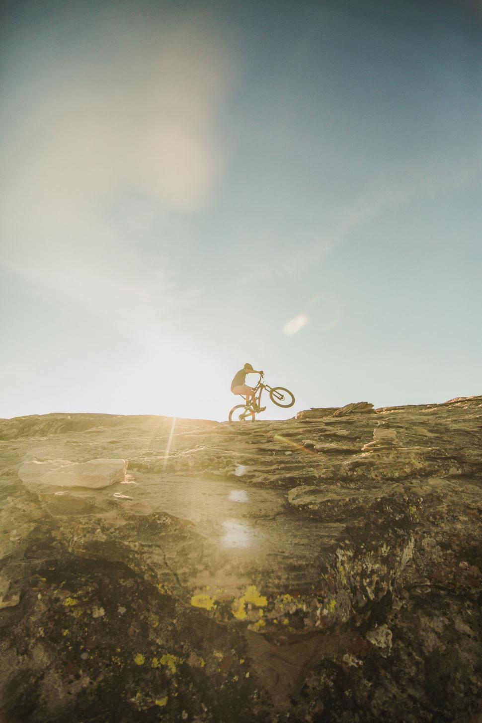 Free Image of Man Riding Bike on Top of Hill 
