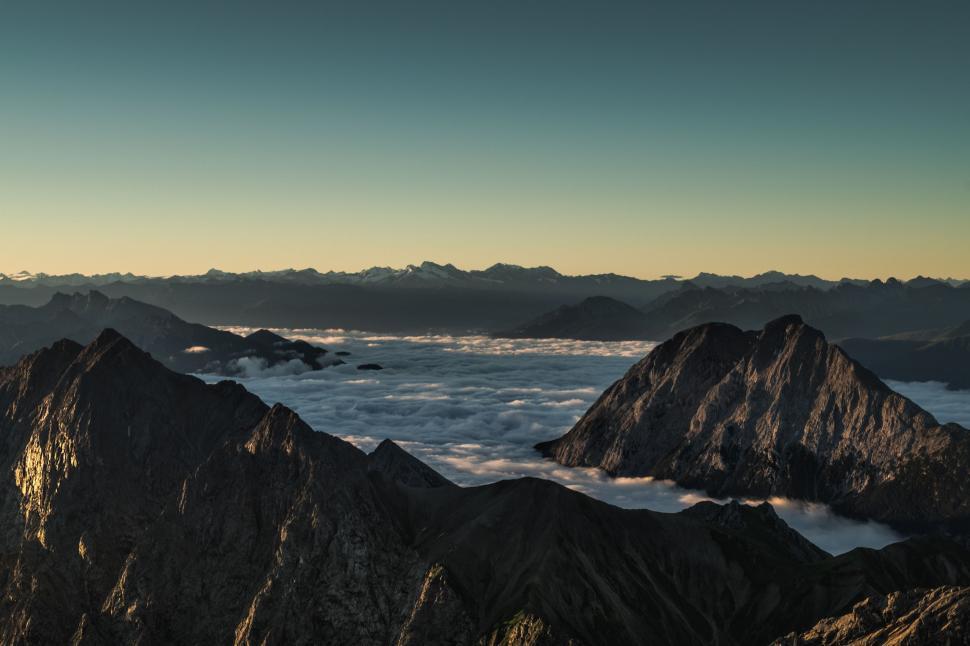 Free Image of Majestic Mountain Range With Clouds in Background 