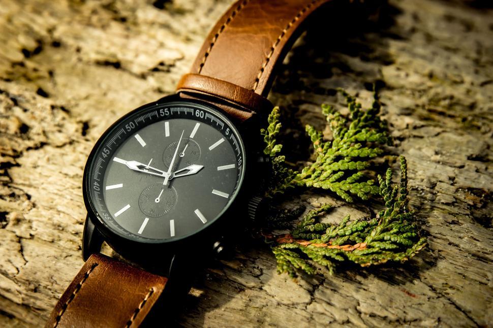 Free Image of Watch Resting on Wooden Surface 