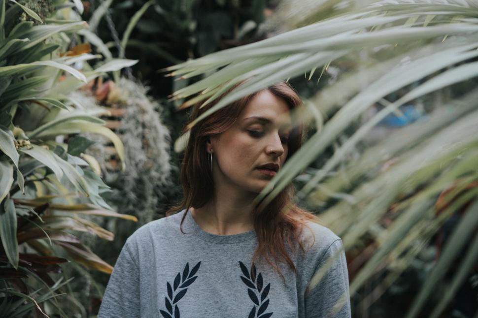 Free Image of Woman Standing in Front of Plants 
