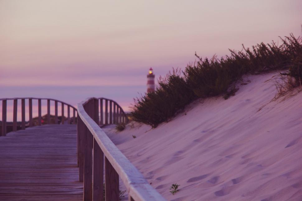 Free Image of Boardwalk Leading to Lighthouse on Beach 