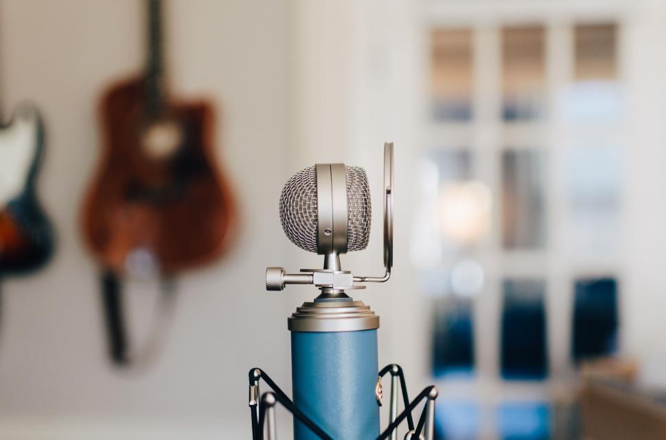 Free Image of Microphone and Guitar in Background 