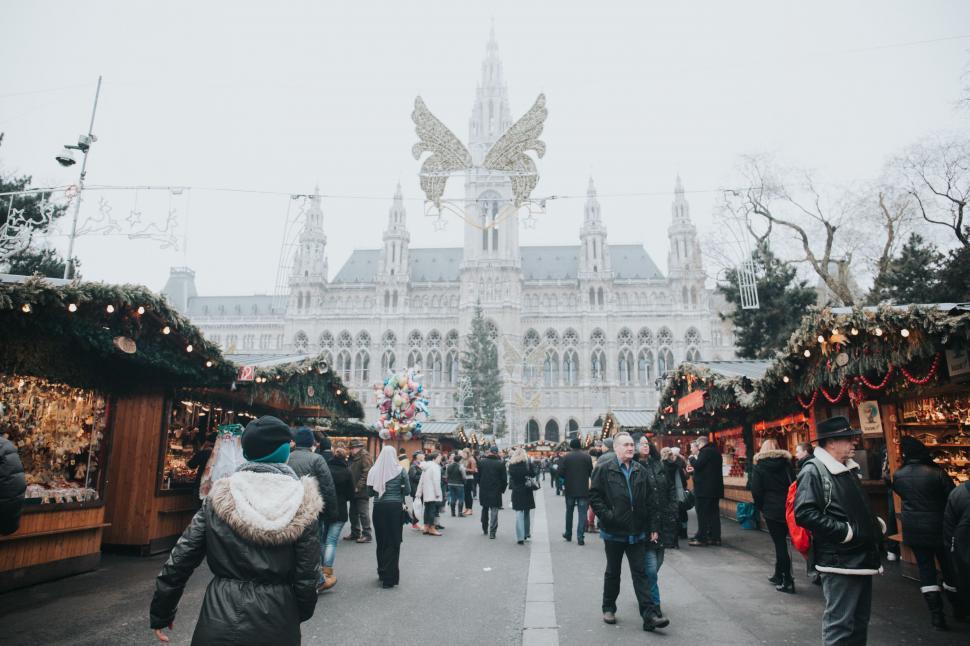 Free Image of Group of People Walking Around a Christmas Market 