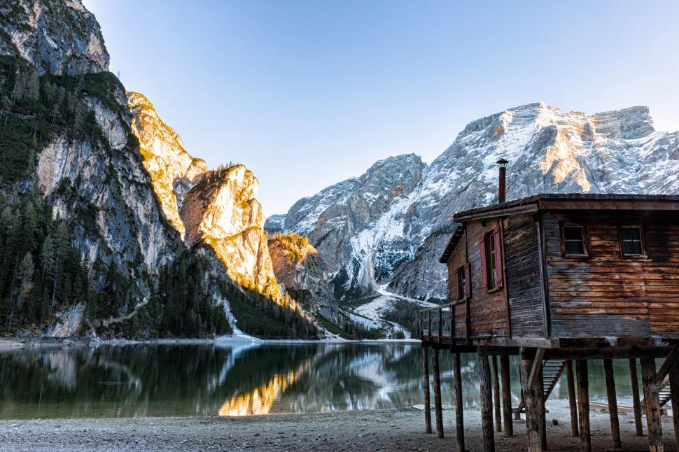 Free Image of Wooden Cabin on Mountain by Lake 