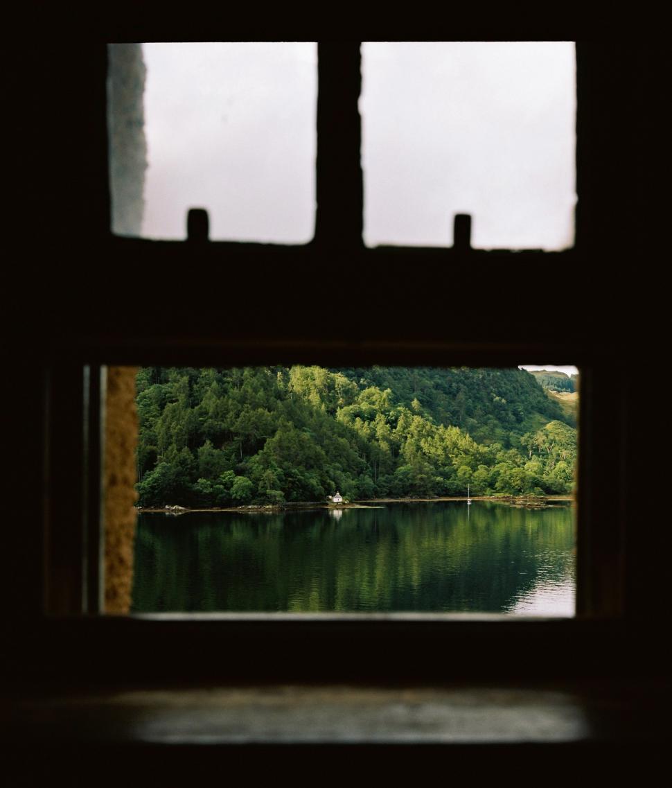 Free Image of A View of a Lake Through a Window 
