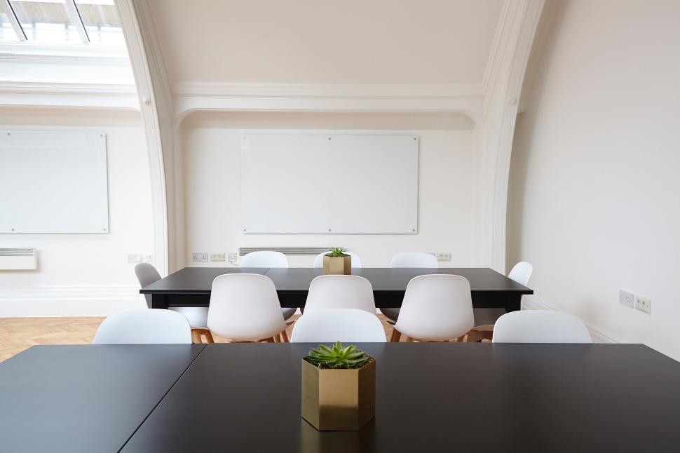 Free Image of Black Table With White Chairs in a Room 