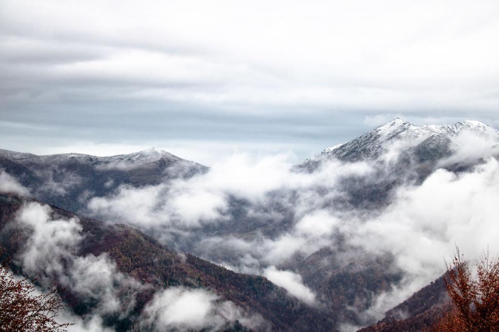 Free Image of Clouds Enveloping Majestic Mountain Peak 