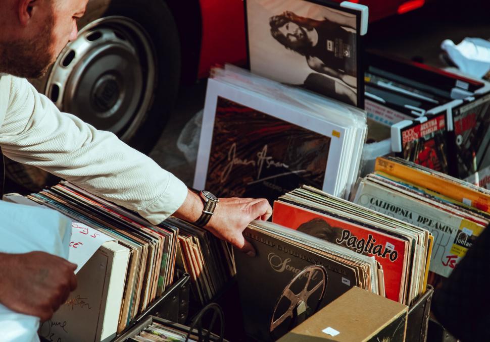 Free Image of Man Looking at Records on Table 