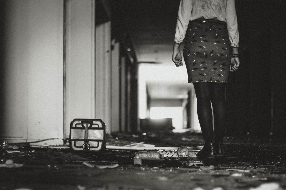 Free Image of Woman Walking Down Hallway 