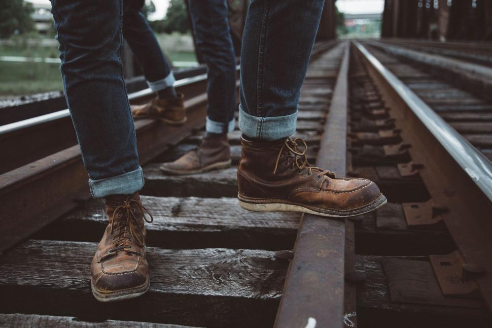 Free Image of Feet Standing on Train Track 