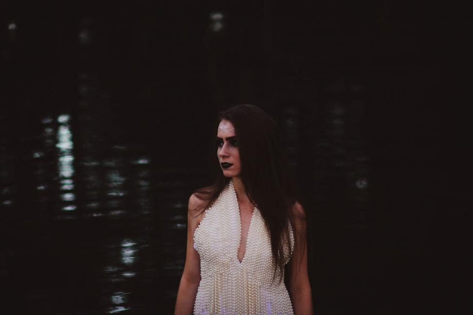 Free Image of Woman in White Dress Standing in Water 