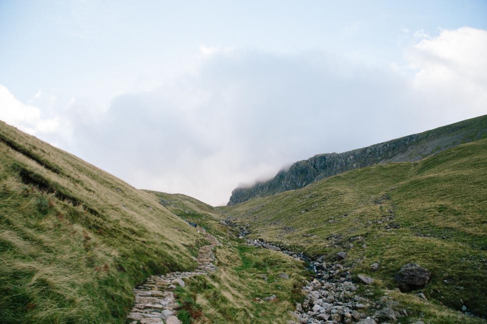 Free Image of Rocky Path Ascending Grassy Hill 