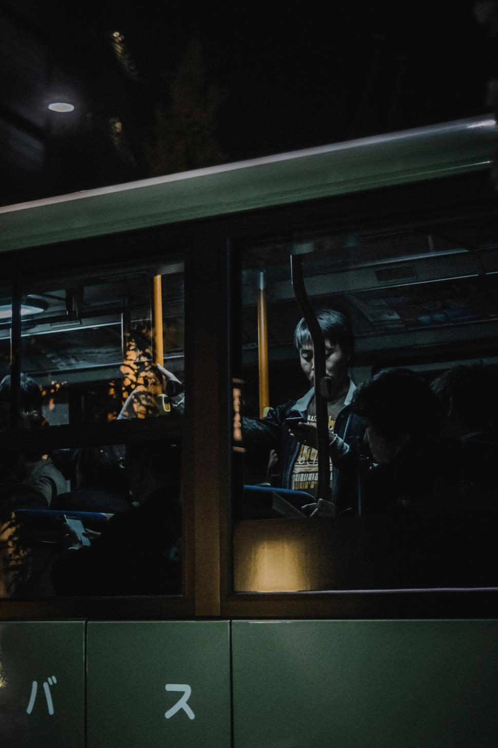 Free Image of Woman Sitting in Bus Looking Out the Window 
