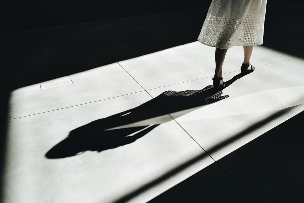 Free Image of Shadow of a Person Walking on a Sidewalk 