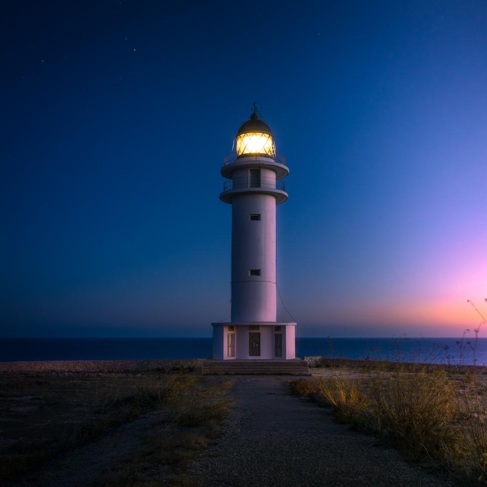 Free Image of Lighthouse Atop Hill by Ocean 