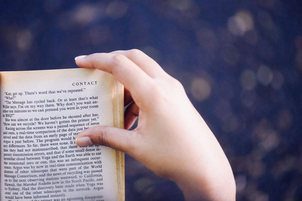 Free Image of Person Holding an Open Book 