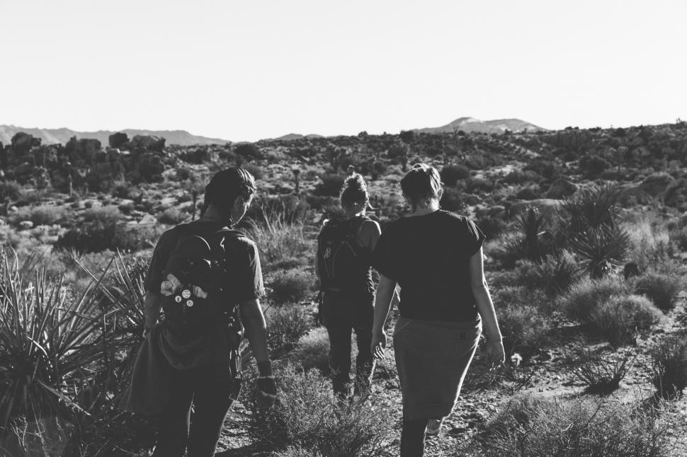 Free Image of Three People Walking in the Desert 