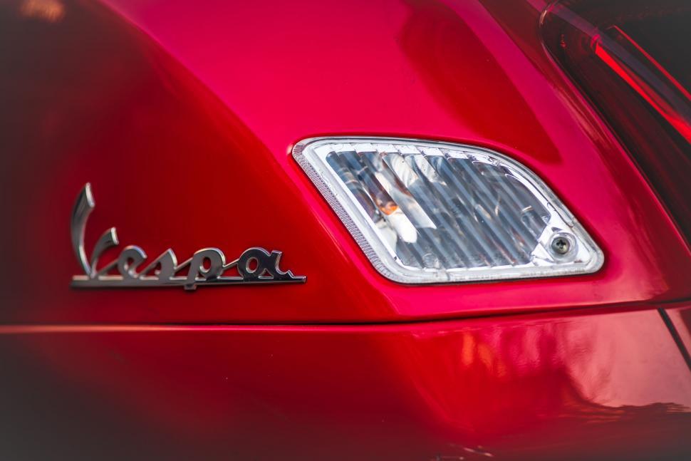 Free Image of Close Up of Emblem on a Red Car 