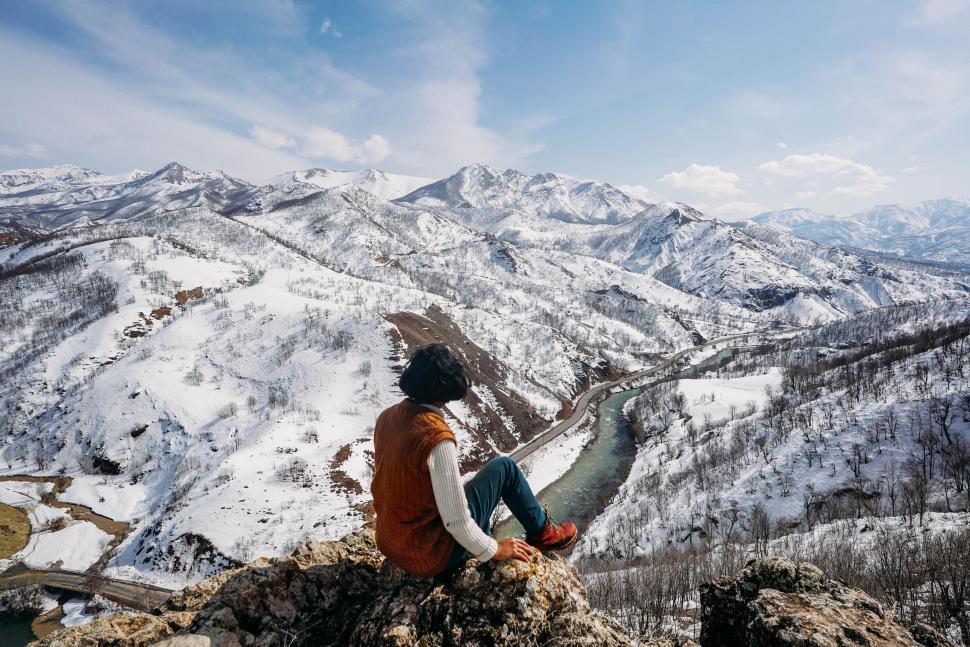 Free Image of Person Sitting on Mountain Overlooking Valley 