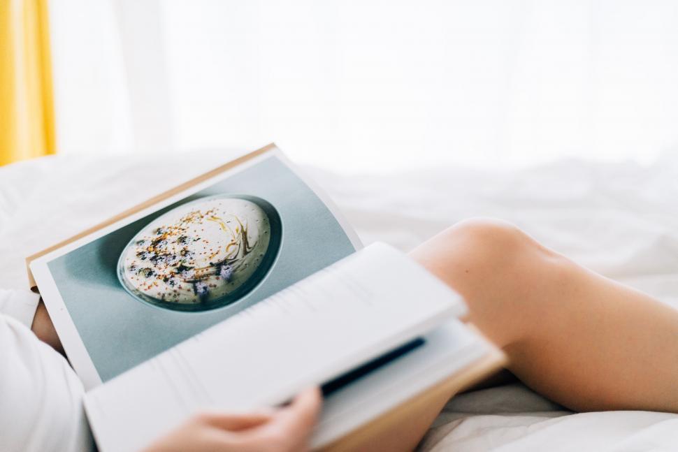 Free Image of Person Reading Book While Laying on Bed 