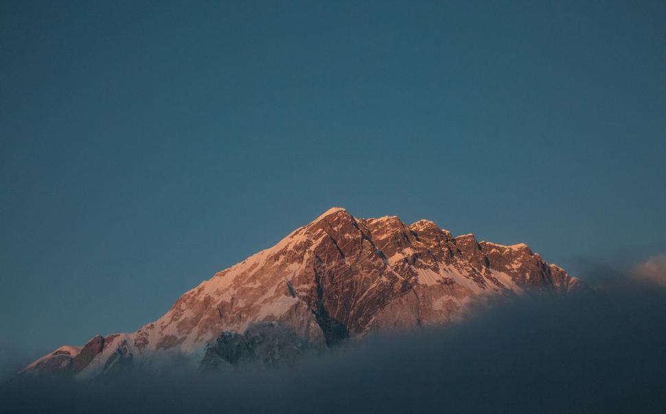Free Image of Snow-Covered Mountain Against Blue Sky 