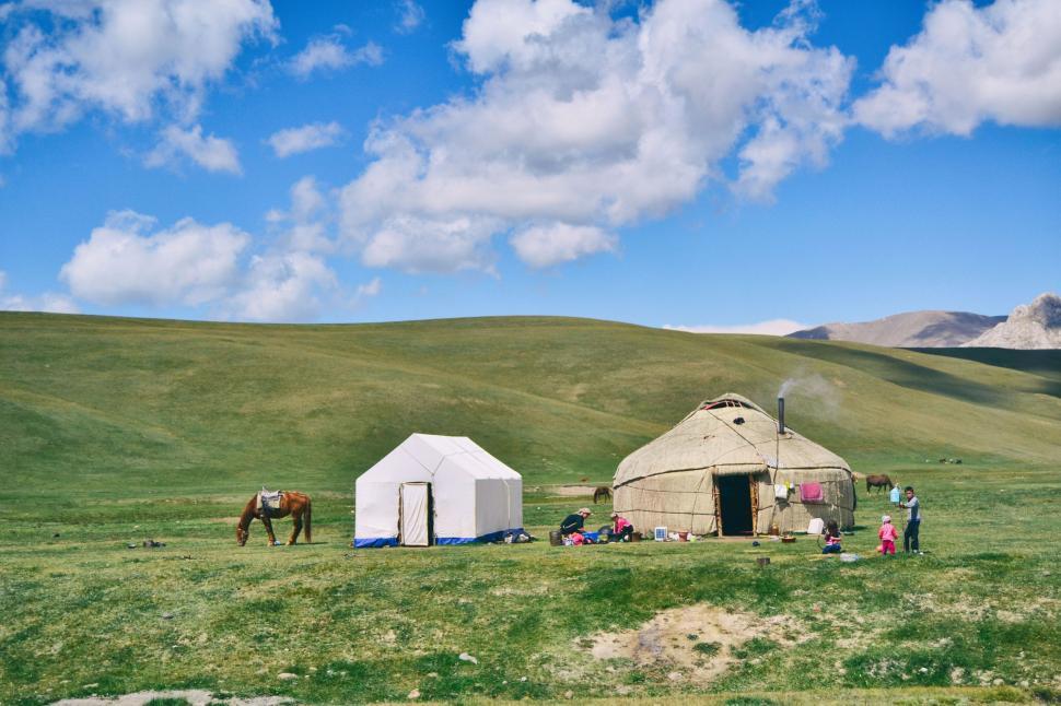 Free Image of Group of People Standing Outside of a Yurt 