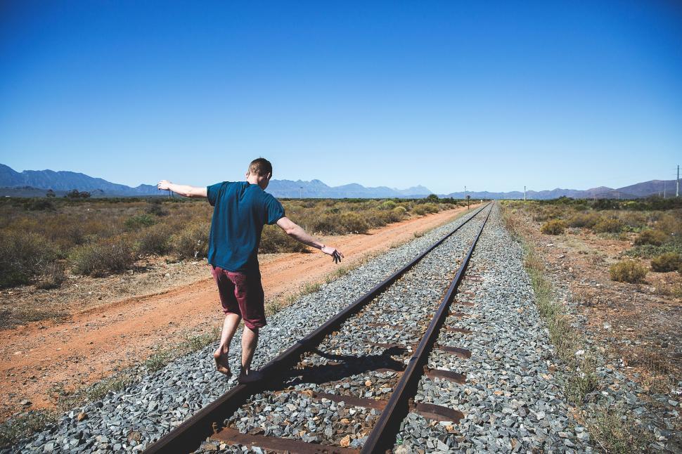 Free Image of Man Standing on Train Tracks in Remote Area 