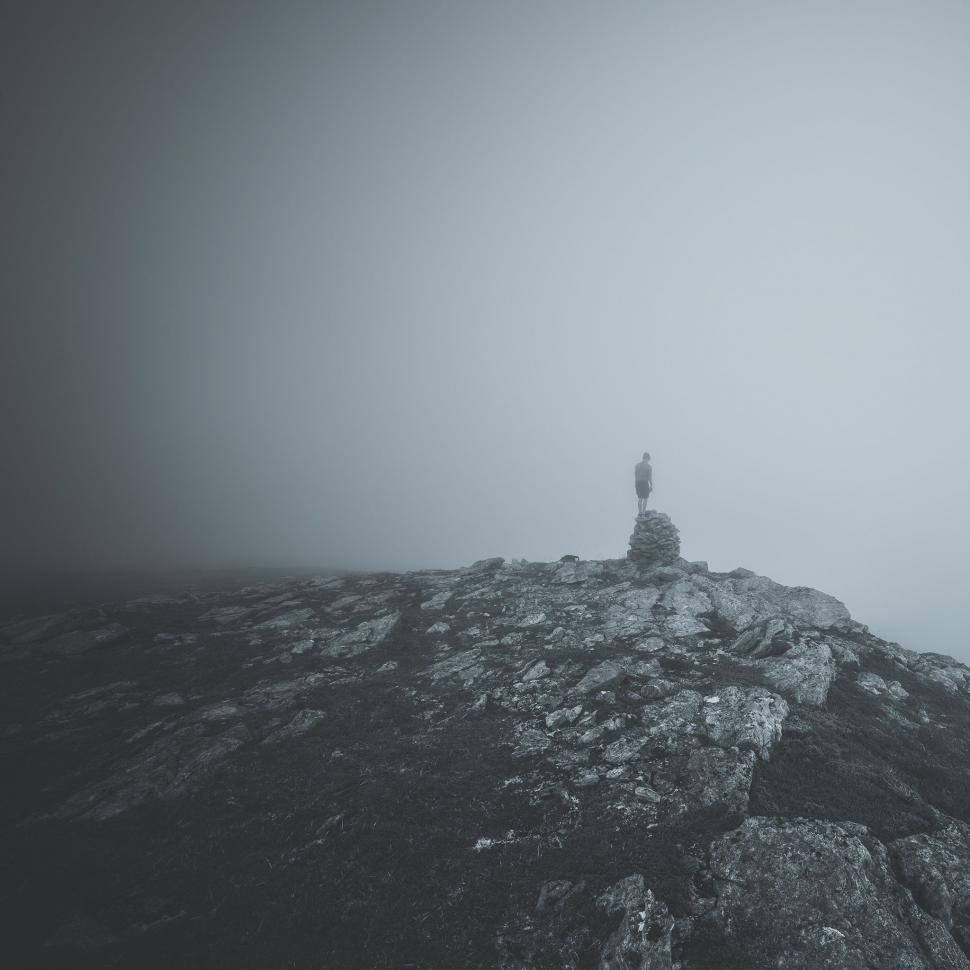 Free Image of Person Standing on Top of Mountain in Fog 
