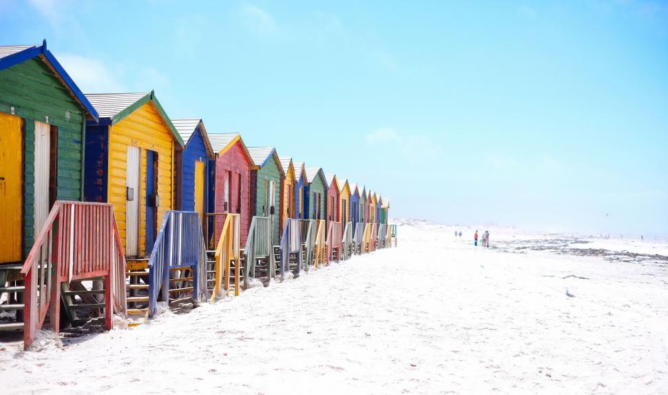 Free Image of Row of Colorful Beach Huts on Sandy Beach 