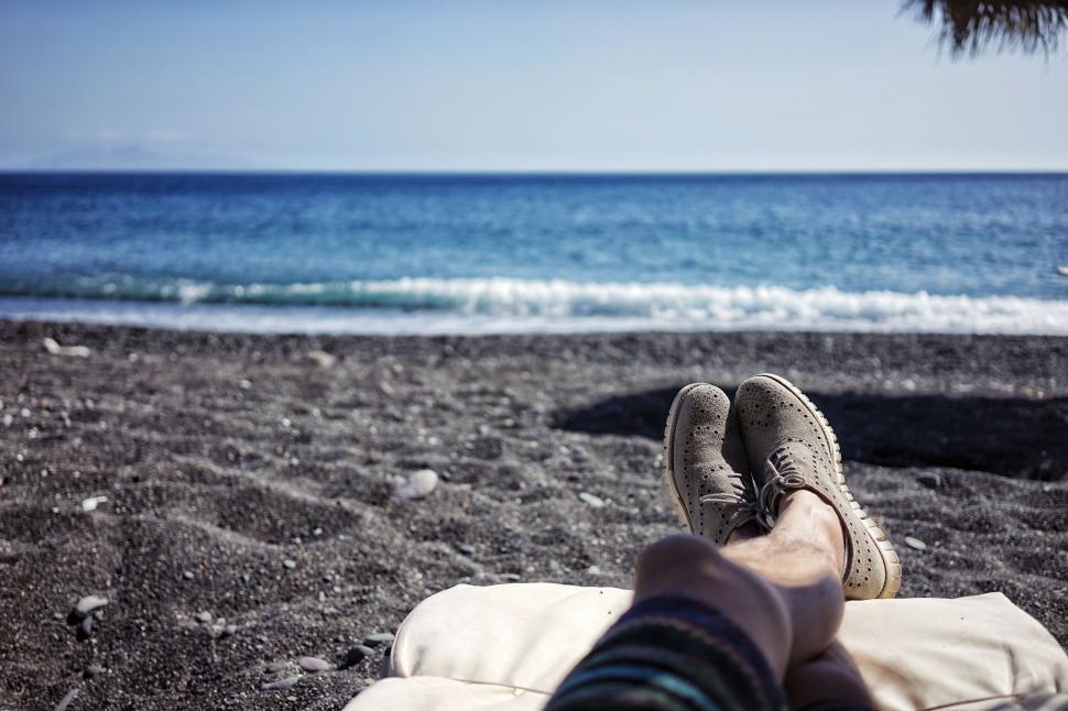 Free Image of Persons Feet Resting on Blanket on Beach 
