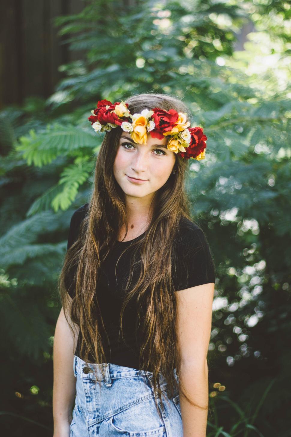 Free Image of Woman Wearing Flower Crown Standing in Front of Forest 